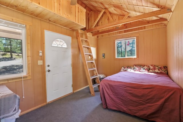 bedroom with beam ceiling, carpet floors, and wood ceiling