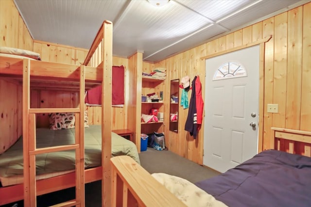 bedroom with wood walls