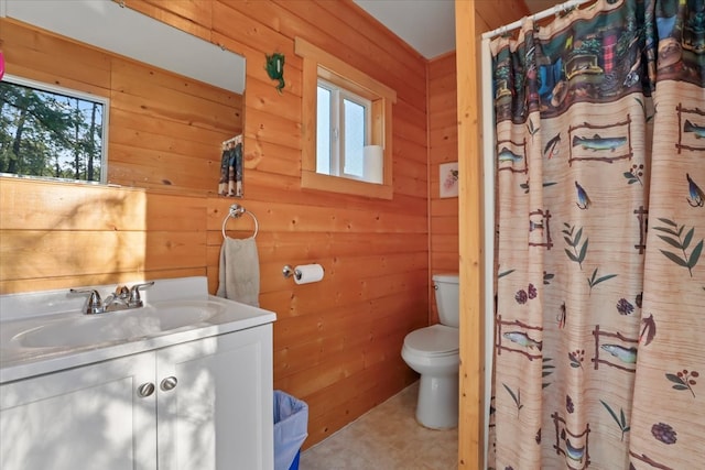 bathroom with wooden walls, plenty of natural light, and toilet