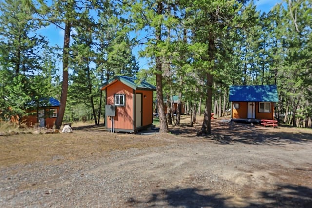 view of front of house with a storage shed