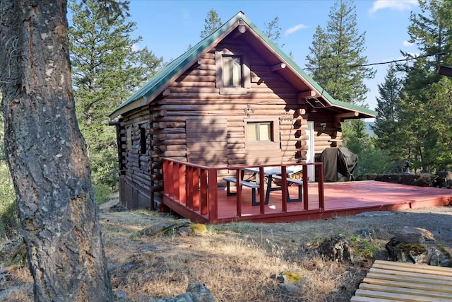 back of property with a wooden deck