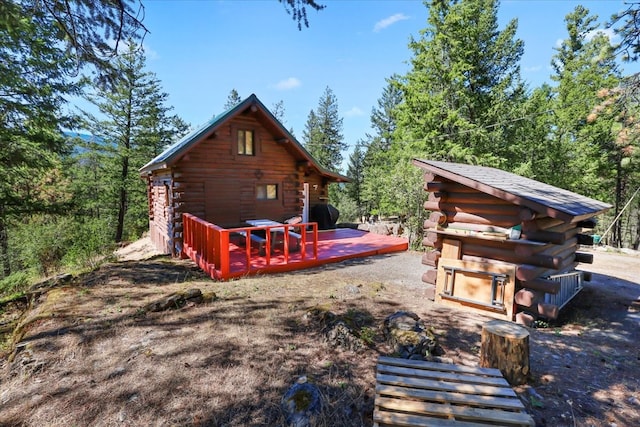 rear view of property featuring a deck