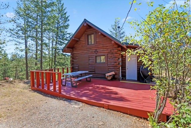 view of side of home with a wooden deck