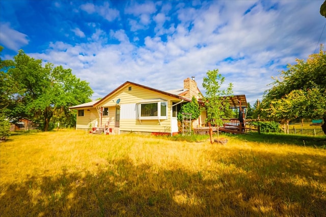 rear view of property with a yard