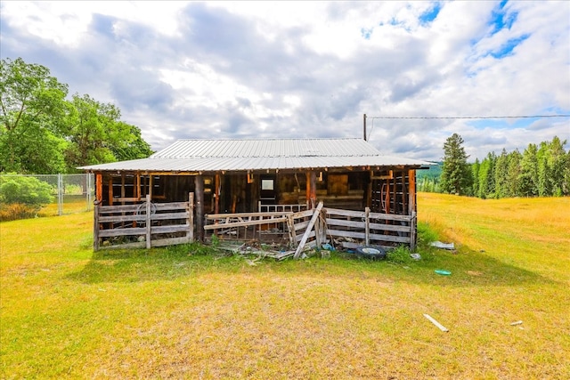 view of horse barn with a yard and an outdoor structure