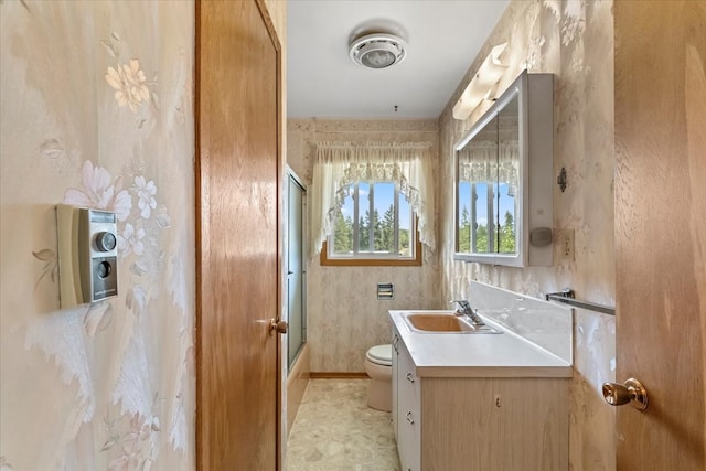 full bathroom with vanity, tile patterned flooring, bath / shower combo with glass door, and toilet