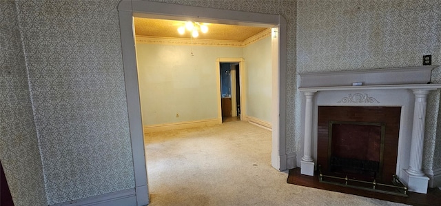 corridor with crown molding, carpet floors, and a textured ceiling