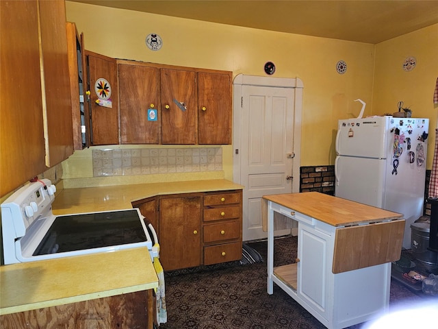 kitchen with backsplash and white appliances