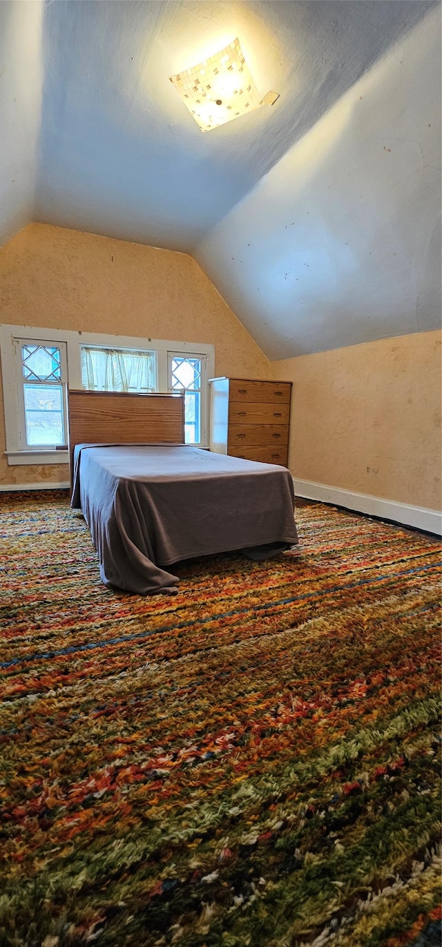 unfurnished bedroom featuring lofted ceiling