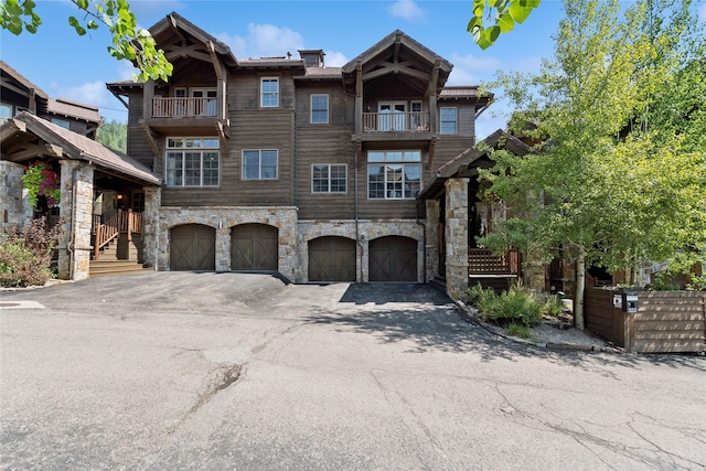 view of front facade featuring a balcony and a garage