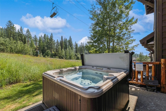 wooden deck featuring a hot tub