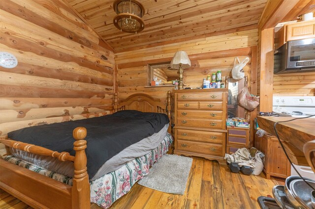 659 US Highway 2 E, Columbia Falls, MT 59912 - bedroom featuring lofted ceiling, wooden ceiling, wood-type flooring, and log walls