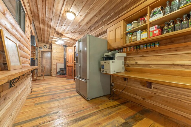 659 US Highway 2 E, Columbia Falls, MT 59912 - kitchen featuring high end refrigerator, wooden walls, a ceiling fan, wood ceiling, and light wood-style floors