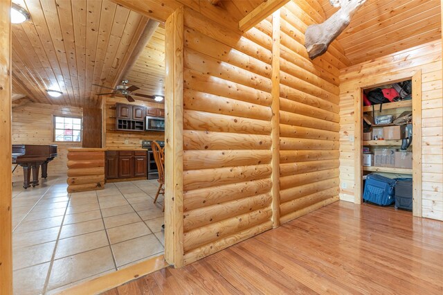 659 US Highway 2 E, Columbia Falls, MT 59912 - interior space with light wood-style flooring, wooden ceiling, log walls, and a ceiling fan