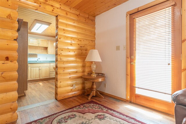 659 US Highway 2 E, Columbia Falls, MT 59912 - interior space with rustic walls, visible vents, light wood-style flooring, wooden ceiling, and baseboards