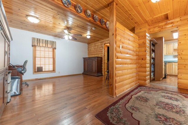 659 US Highway 2 E, Columbia Falls, MT 59912 - living room with log walls, ceiling fan, light wood-type flooring, wooden ceiling, and baseboards