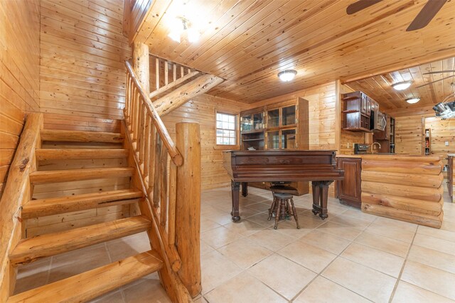 659 US Highway 2 E, Columbia Falls, MT 59912 - staircase with wood walls, wood ceiling, a ceiling fan, and tile patterned floors