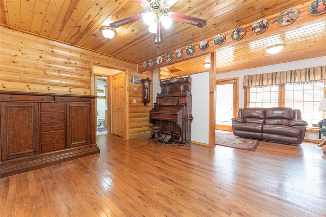659 US Highway 2 E, Columbia Falls, MT 59912 - living room featuring light wood-style floors, wooden ceiling, rustic walls, and ceiling fan