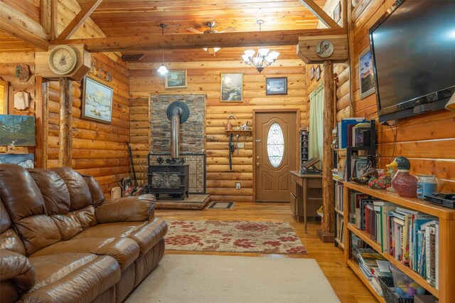 659 US Highway 2 E, Columbia Falls, MT 59912 - living room featuring a wood stove, an inviting chandelier, and wood finished floors