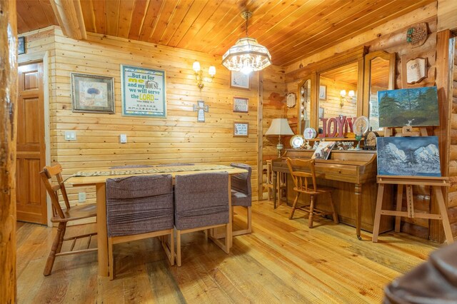 659 US Highway 2 E, Columbia Falls, MT 59912 - dining space with wooden ceiling, light wood-style flooring, wooden walls, and a notable chandelier