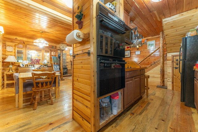 659 US Highway 2 E, Columbia Falls, MT 59912 - kitchen featuring wooden ceiling, wooden walls, light wood-type flooring, freestanding refrigerator, and an inviting chandelier