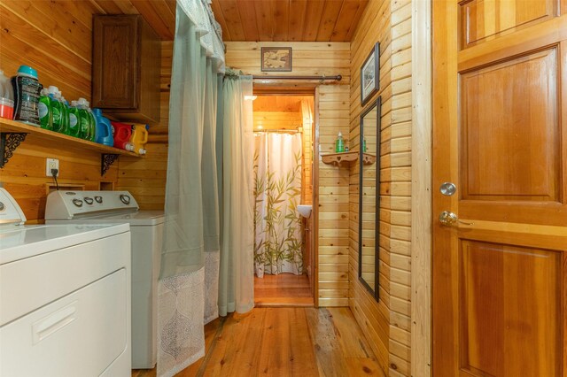 659 US Highway 2 E, Columbia Falls, MT 59912 - laundry room featuring laundry area, independent washer and dryer, wooden walls, and light wood finished floors