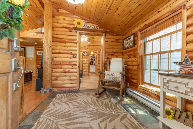 659 US Highway 2 E, Columbia Falls, MT 59912 - living area with lofted ceiling, wood ceiling, stone tile floors, and a baseboard radiator