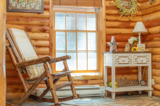 659 US Highway 2 E, Columbia Falls, MT 59912 - sitting room with a baseboard heating unit, plenty of natural light, and log walls