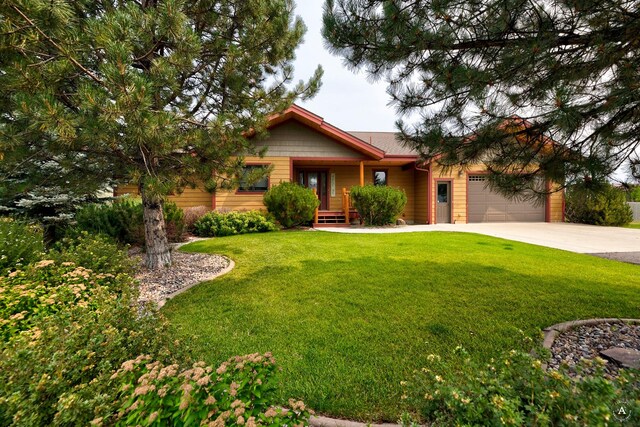 view of front of house with a garage and a front yard