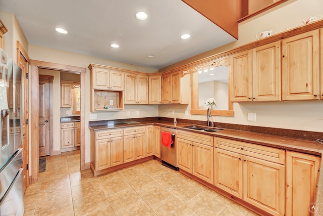 kitchen with dishwashing machine, light tile patterned floors, sink, and light brown cabinetry