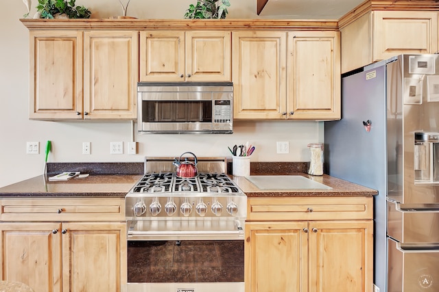 kitchen featuring tile patterned floors, stainless steel appliances, and light brown cabinetry