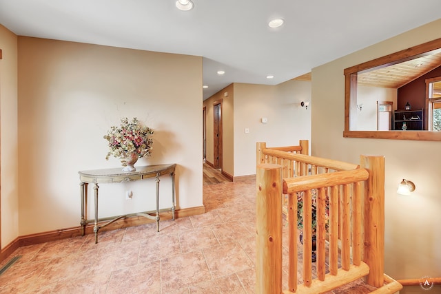 corridor featuring lofted ceiling and tile patterned floors