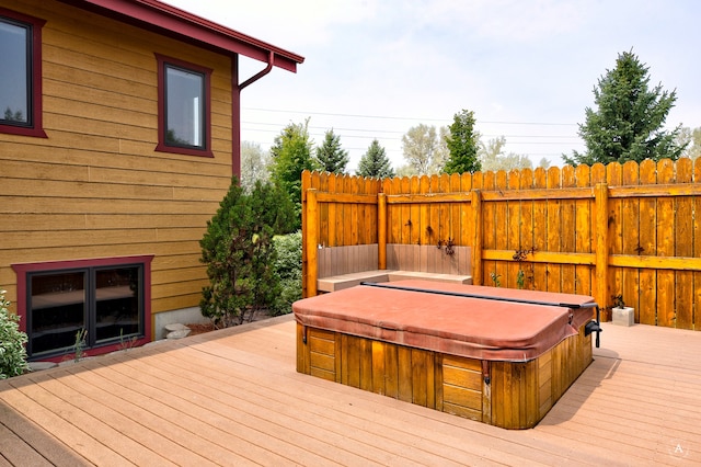 wooden deck featuring a covered hot tub