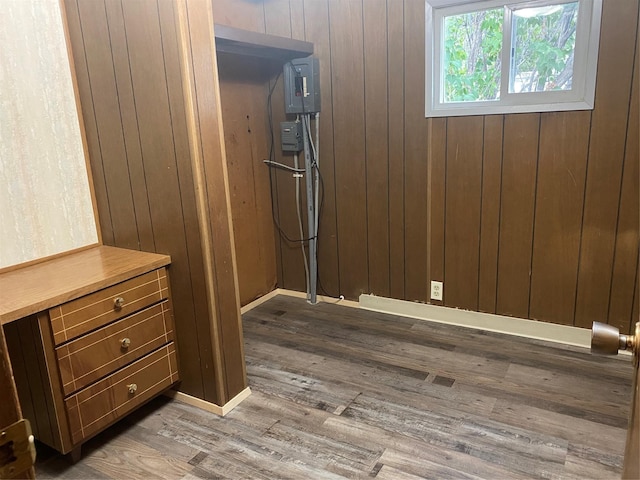 interior space featuring hardwood / wood-style floors and wood walls