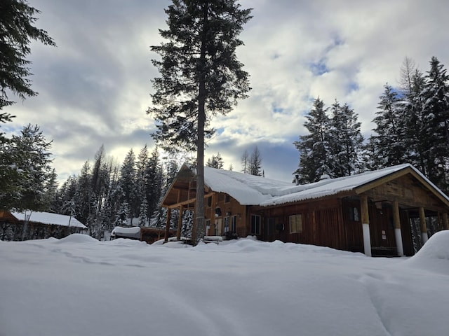 snow covered property featuring board and batten siding