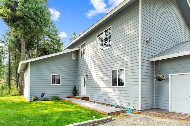 rear view of property featuring a lawn