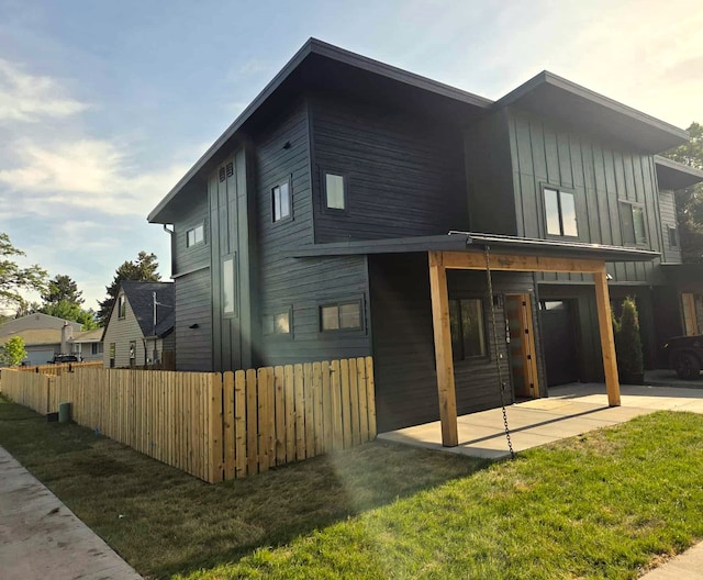 940 Kemp St Unit A, Missoula, MT 59801 - back of house featuring a patio area and board and batten siding