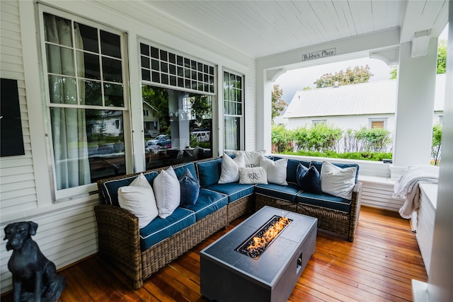 deck featuring an outdoor living space with a fire pit