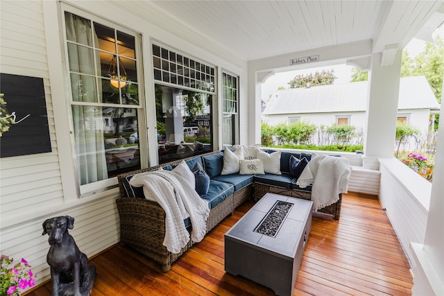 wooden deck with an outdoor living space