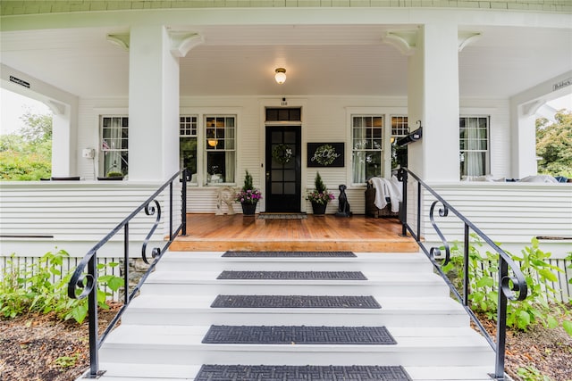 view of exterior entry with covered porch