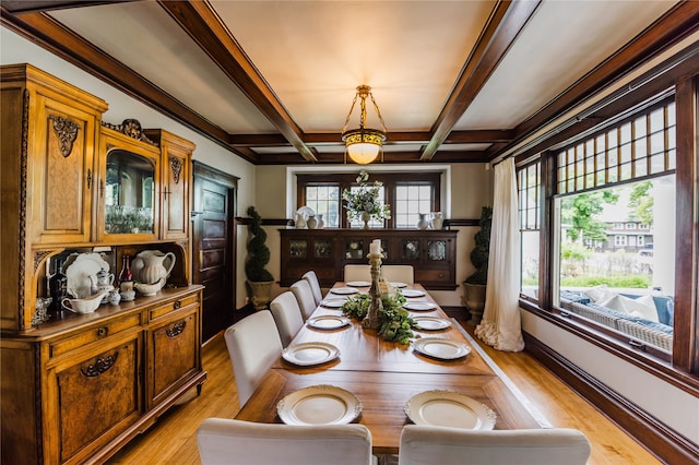 dining area featuring beamed ceiling, coffered ceiling, and light hardwood / wood-style flooring