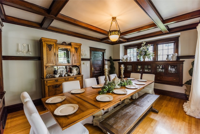 dining room with beam ceiling, light hardwood / wood-style floors, and coffered ceiling