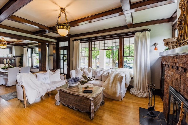 living room with coffered ceiling, light hardwood / wood-style flooring, and beam ceiling