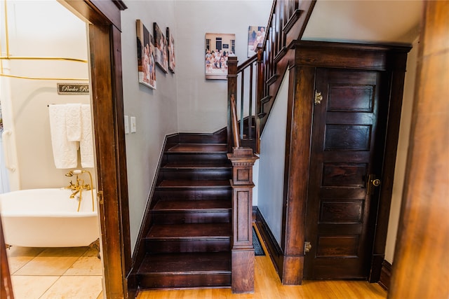 stairs with hardwood / wood-style flooring