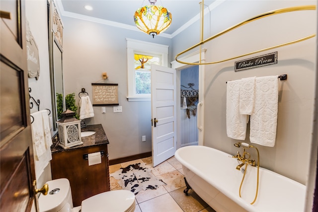 bathroom with a tub to relax in, vanity, crown molding, toilet, and tile patterned floors