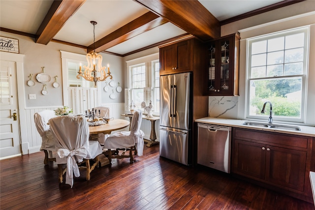 interior space featuring an inviting chandelier, a wealth of natural light, dark hardwood / wood-style floors, and sink