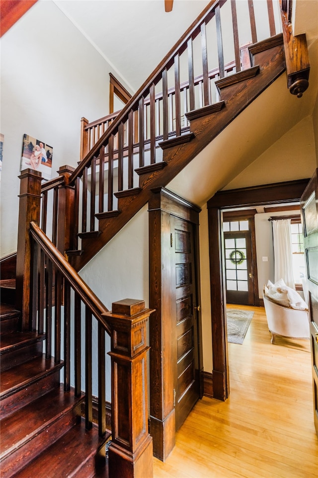 staircase with hardwood / wood-style flooring