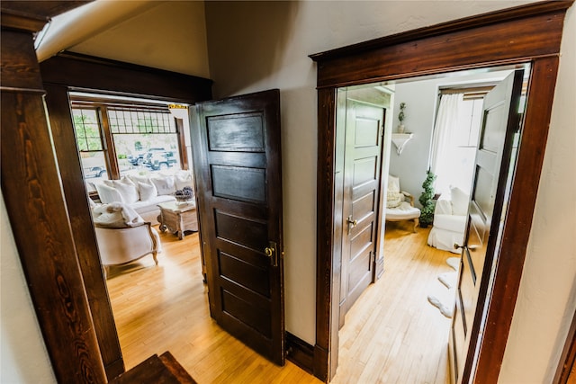 hallway with light hardwood / wood-style floors