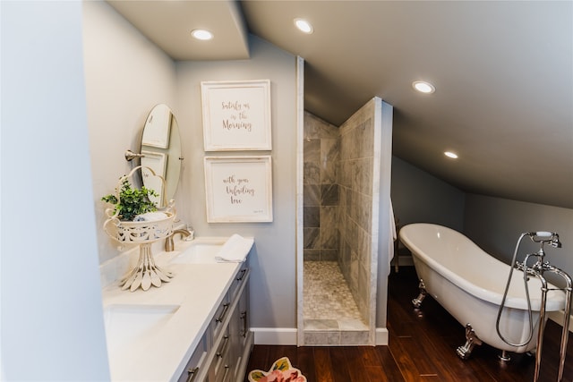 bathroom with shower with separate bathtub, vaulted ceiling, hardwood / wood-style floors, and vanity