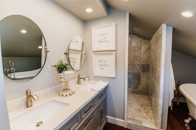 bathroom with wood-type flooring, vanity, and plus walk in shower